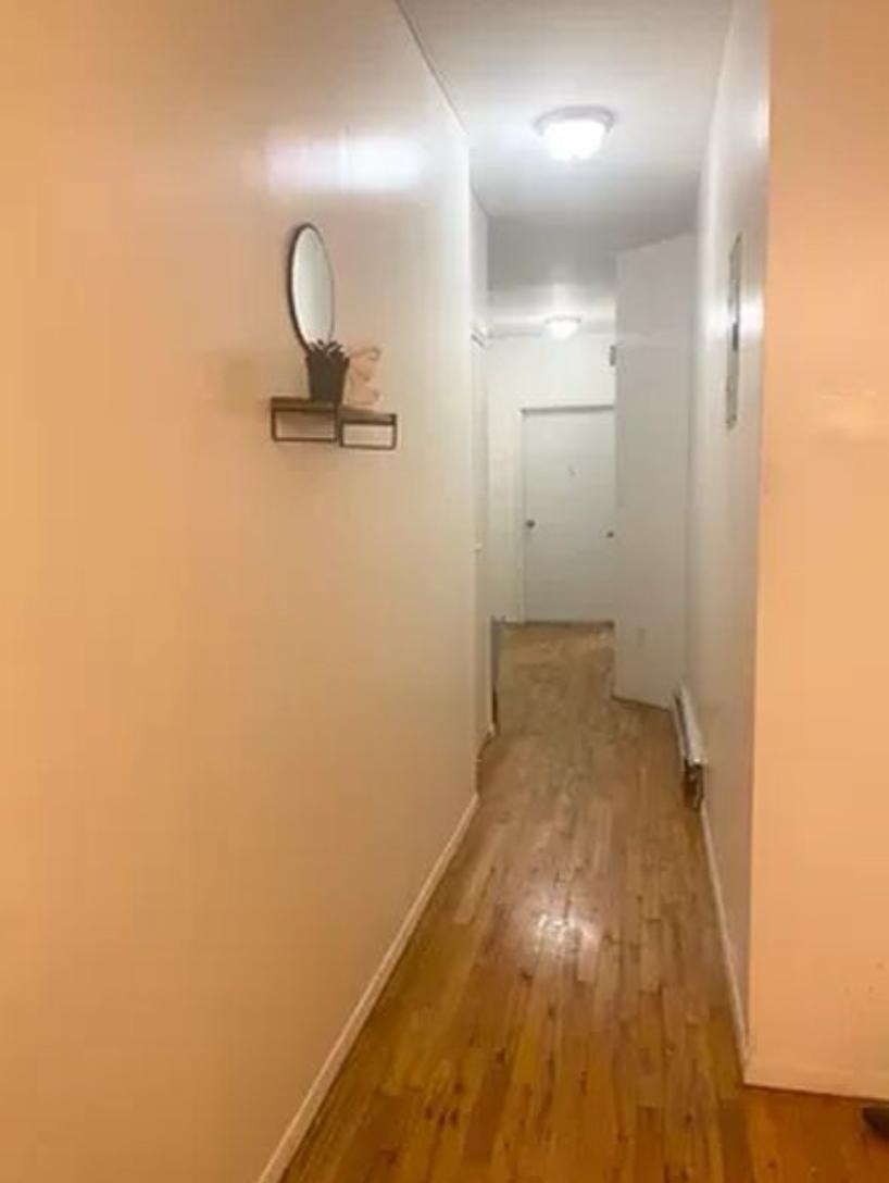 1047 Faile Street, Unit 1047A Bronx, NY 10459 - Photo 8 of 10 a view of a room with wooden floor