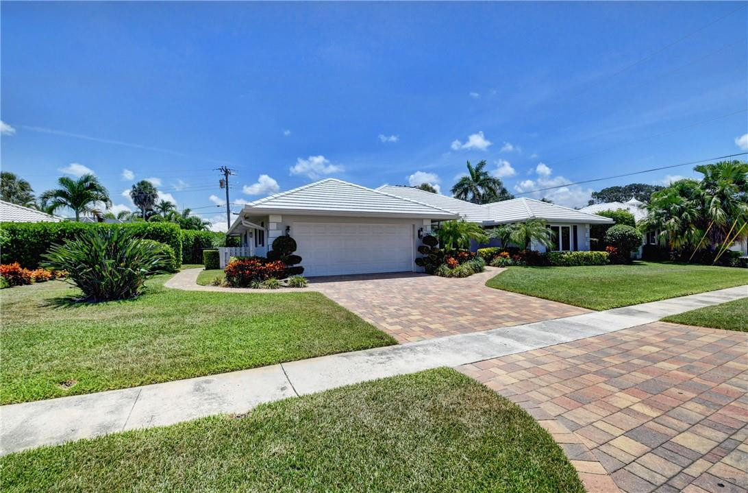1163 Mulberry Way Boca Raton, FL 33486 - Photo 13 of 66 a front view of a house with a yard and garage