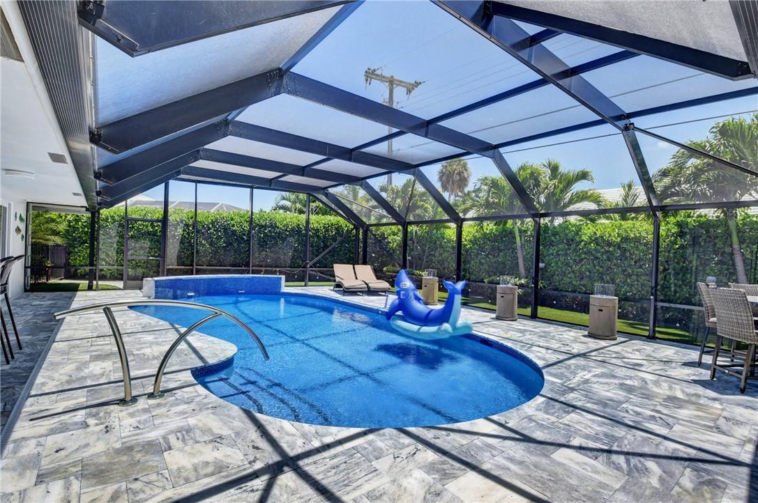 1163 Mulberry Way Boca Raton, FL 33486 - Photo 18 of 66 a view of a swimming pool with a patio