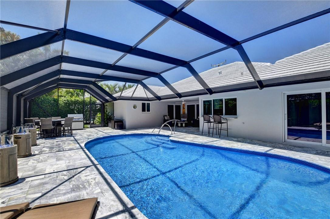 1163 Mulberry Way Boca Raton, FL 33486 - Photo 23 of 66 a view of a swimming pool with a patio