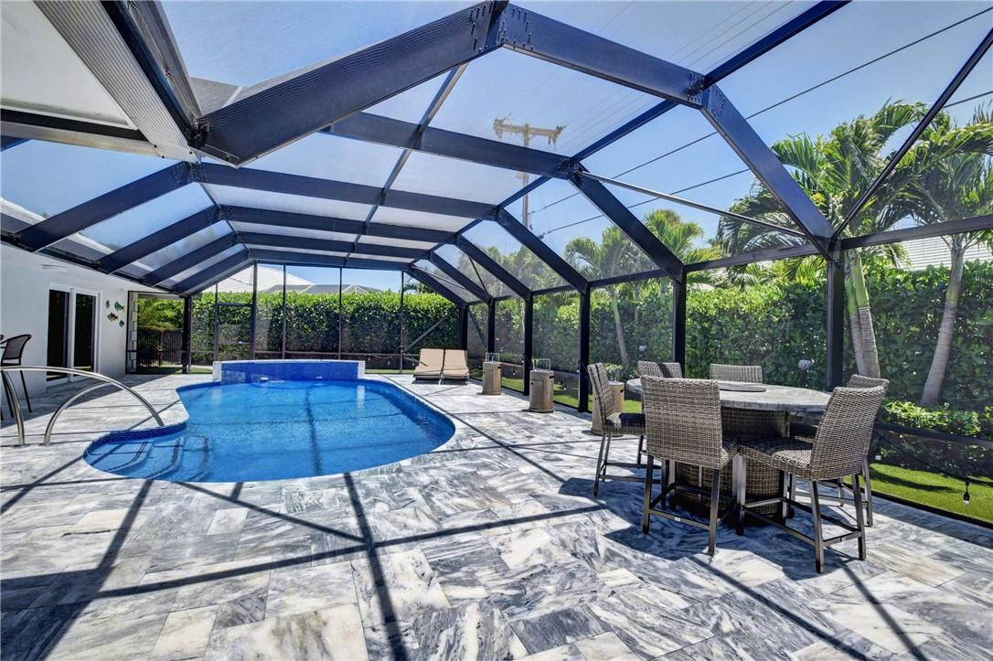 1163 Mulberry Way Boca Raton, FL 33486 - Photo 26 of 66 a view of patio with dining table and chairs under an umbrella