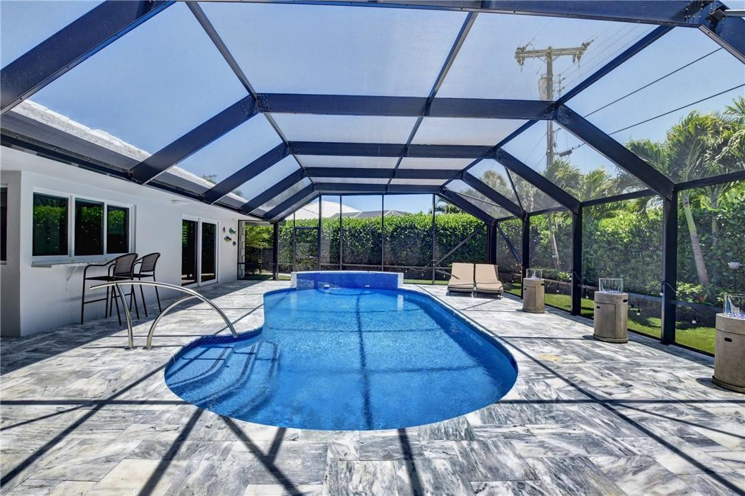 1163 Mulberry Way Boca Raton, FL 33486 - Photo 30 of 66 a view of a swimming pool with a patio