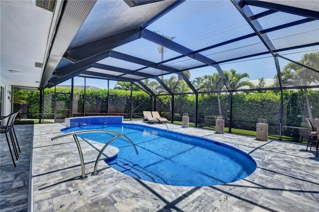 1163 Mulberry Way Boca Raton, FL 33486 - Photo 31 of 66 a view of pool with table and chairs under an umbrella