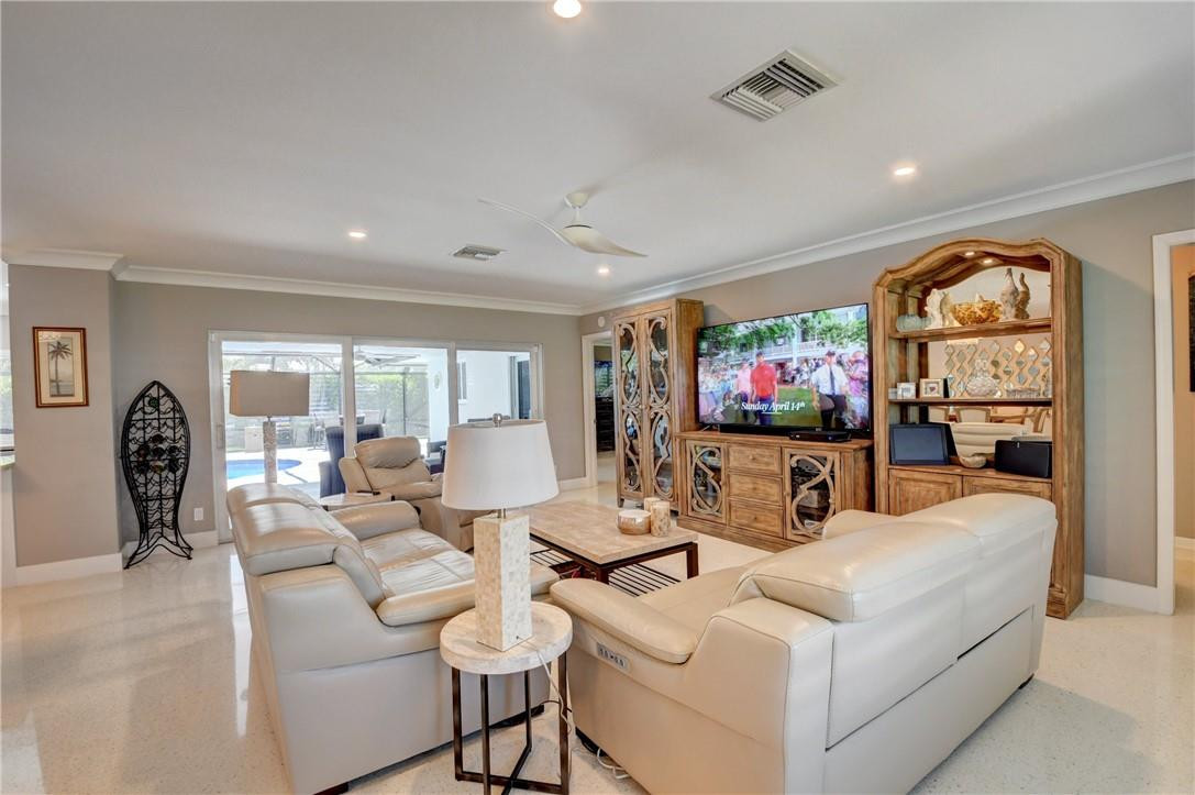 1163 Mulberry Way Boca Raton, FL 33486 - Photo 36 of 66 a living room with furniture a flat screen tv and a floor to ceiling window