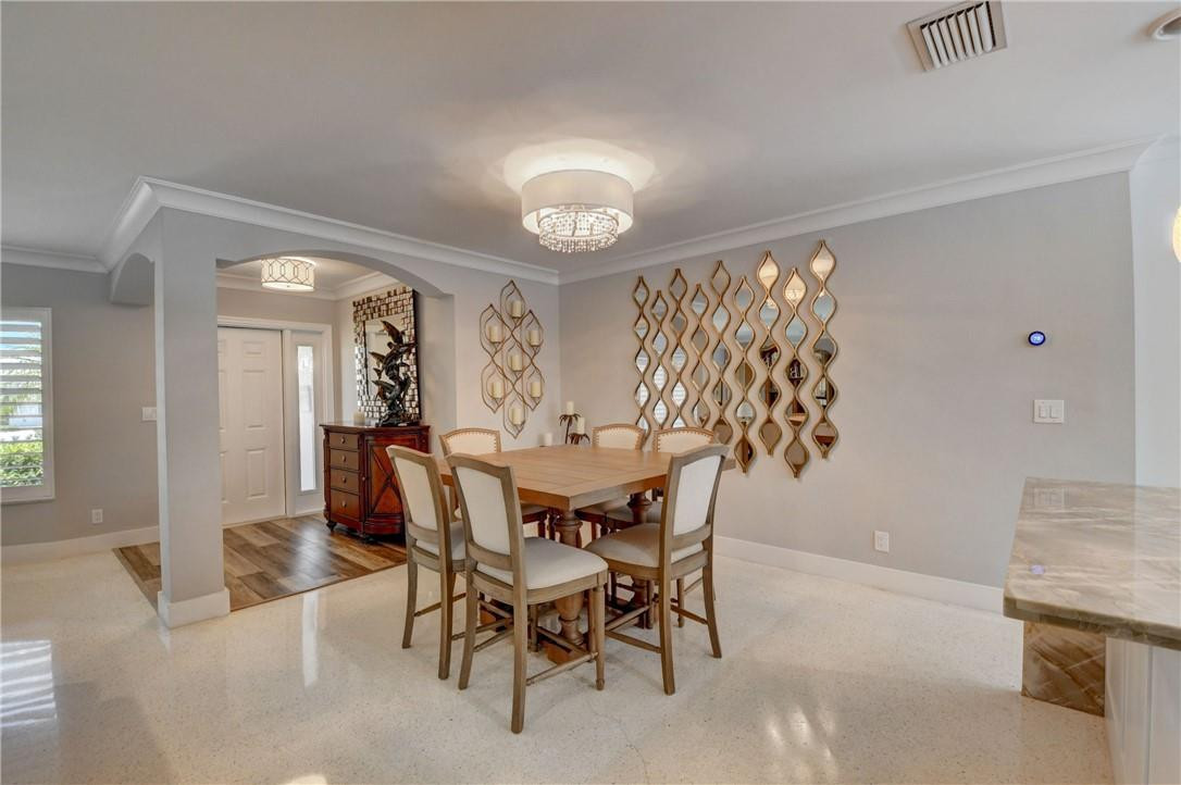 1163 Mulberry Way Boca Raton, FL 33486 - Photo 39 of 66 a view of a dining room with furniture and chandelier