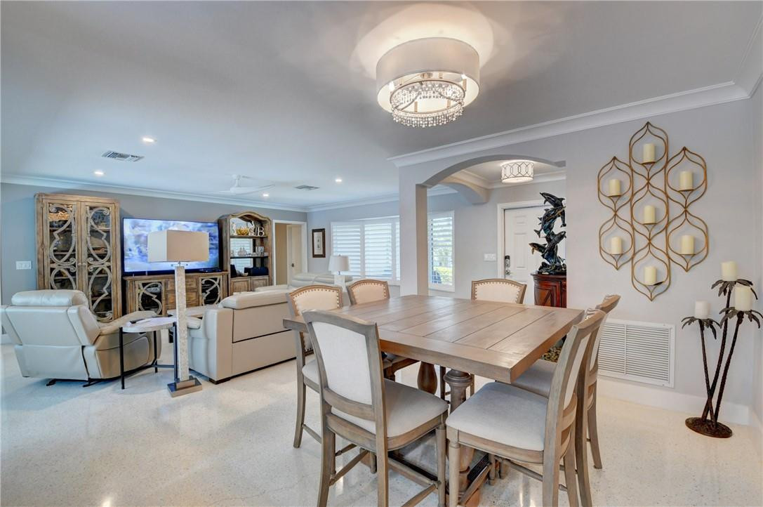 1163 Mulberry Way Boca Raton, FL 33486 - Photo 40 of 66 a view of a dining room with furniture and a chandelier