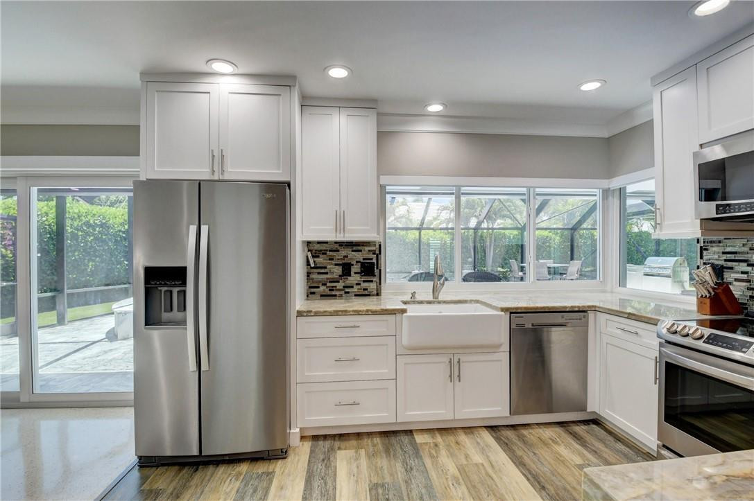 1163 Mulberry Way Boca Raton, FL 33486 - Photo 43 of 66 a kitchen with a refrigerator and a sink