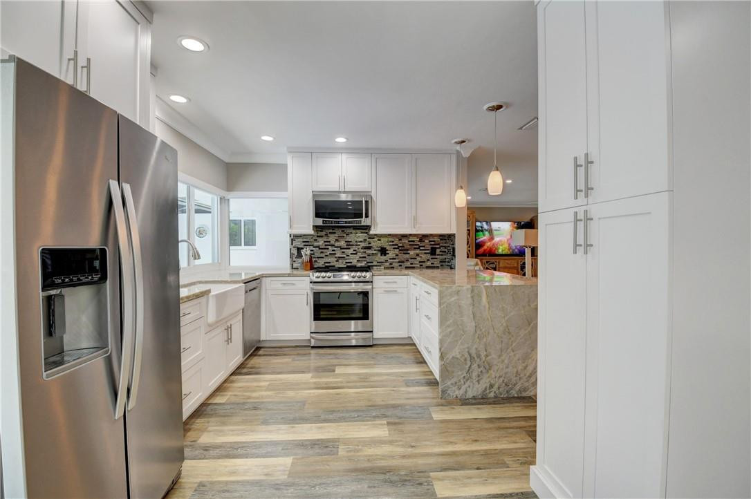 1163 Mulberry Way Boca Raton, FL 33486 - Photo 44 of 66 a kitchen with stainless steel appliances a refrigerator sink and microwave