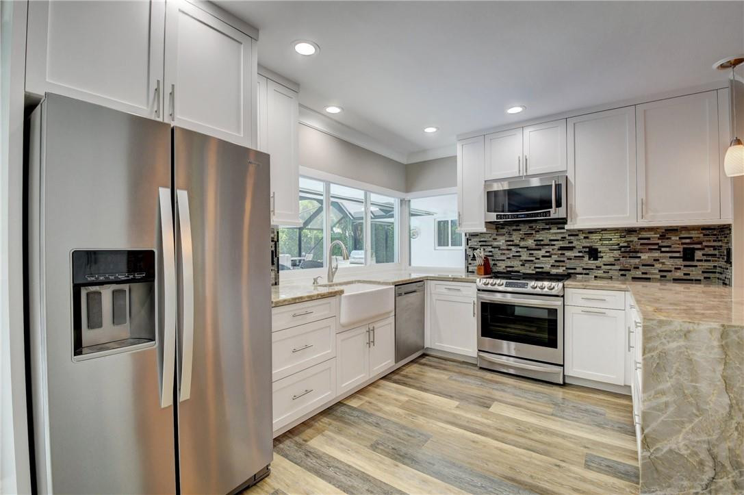 1163 Mulberry Way Boca Raton, FL 33486 - Photo 45 of 66 a kitchen with stainless steel appliances a refrigerator stove and microwave