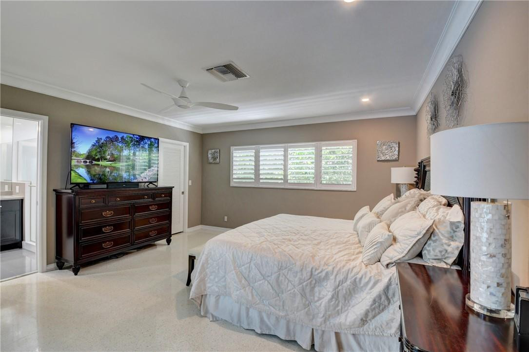 1163 Mulberry Way Boca Raton, FL 33486 - Photo 54 of 66 a bedroom with a bed and a television