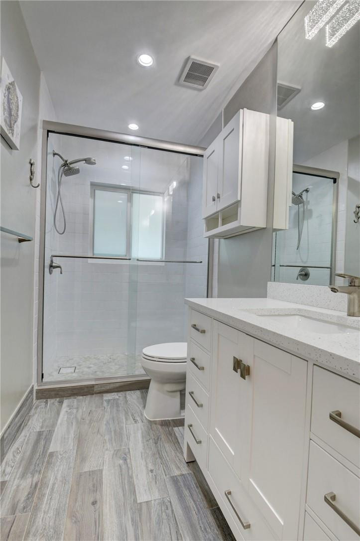 1163 Mulberry Way Boca Raton, FL 33486 - Photo 64 of 66 a bathroom with a sink a toilet and mirror
