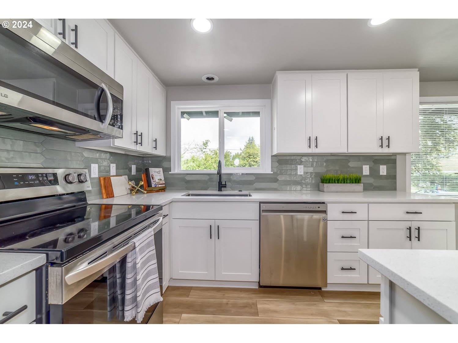 375 Heritage Avenue Eugene, OR 97404 - Photo 11 of 32 a kitchen with stainless steel appliances granite countertop a stove a sink and a microwave