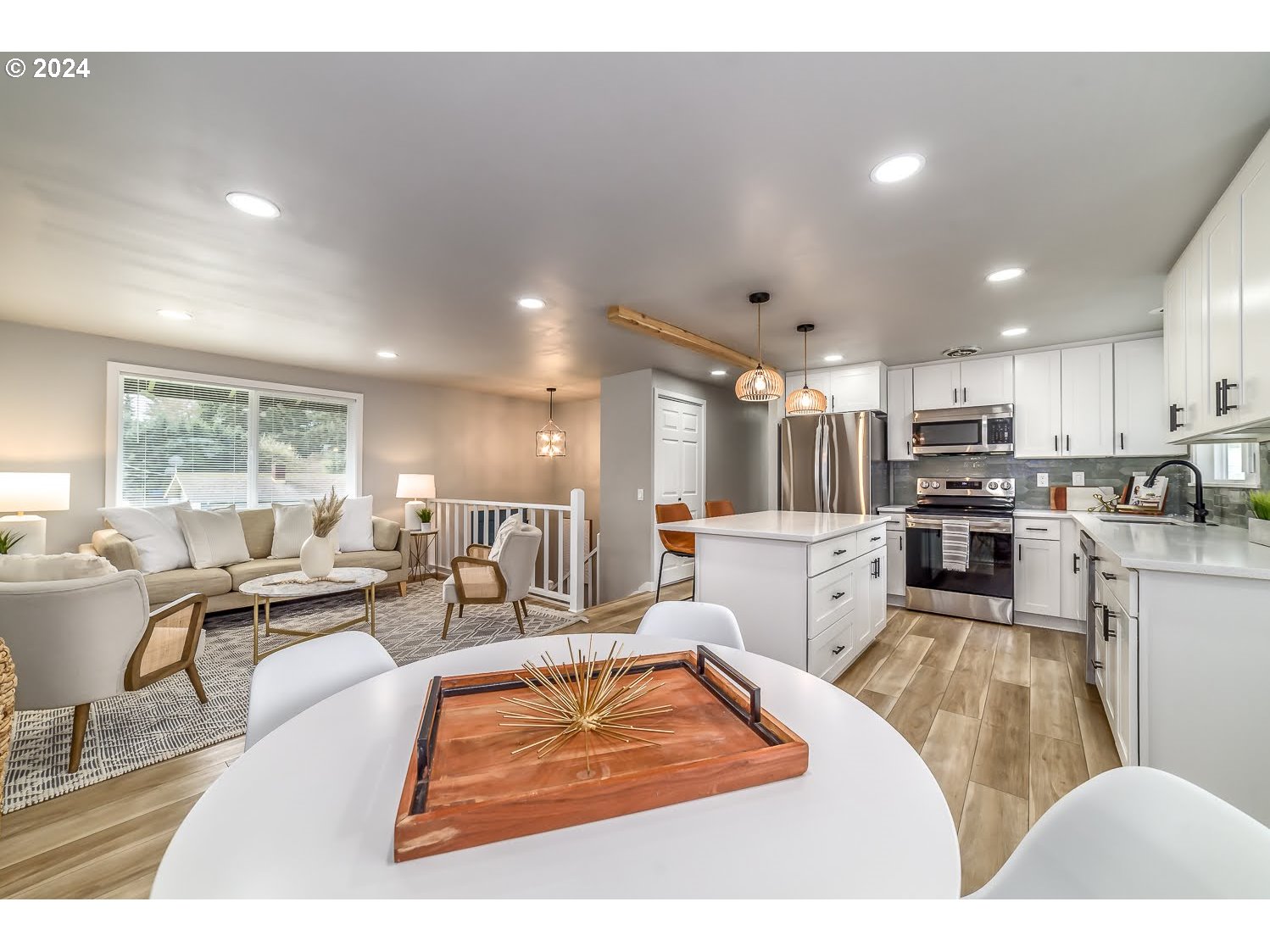 375 Heritage Avenue Eugene, OR 97404 - Photo 5 of 32 a living room with stainless steel appliances kitchen island granite countertop a refrigerator a sink dishwasher a dining table and chairs with wooden floor