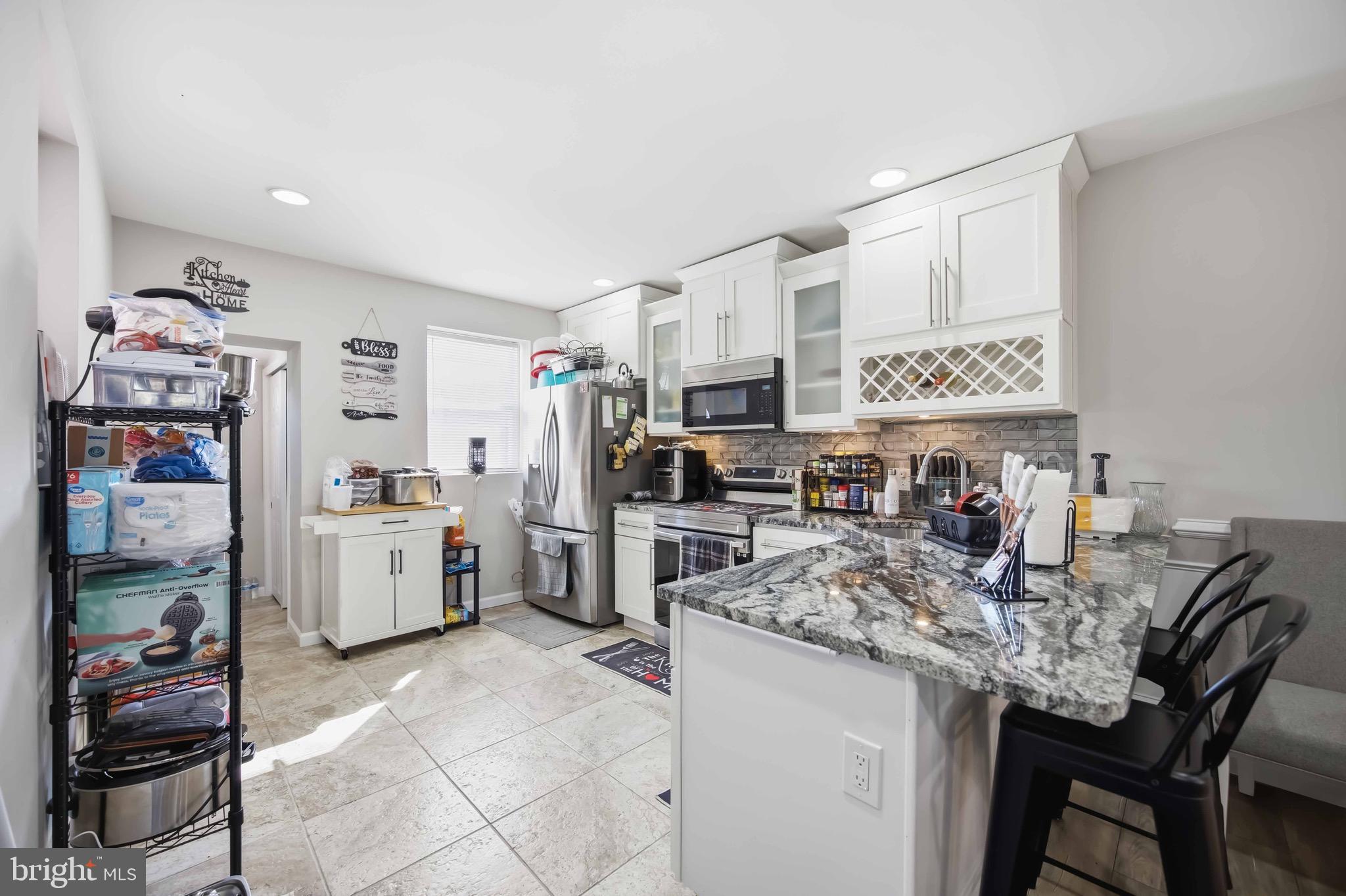 7167 Georgian Road Philadelphia, PA 19138 - Photo 14 of 34 a kitchen with refrigerator and cabinets
