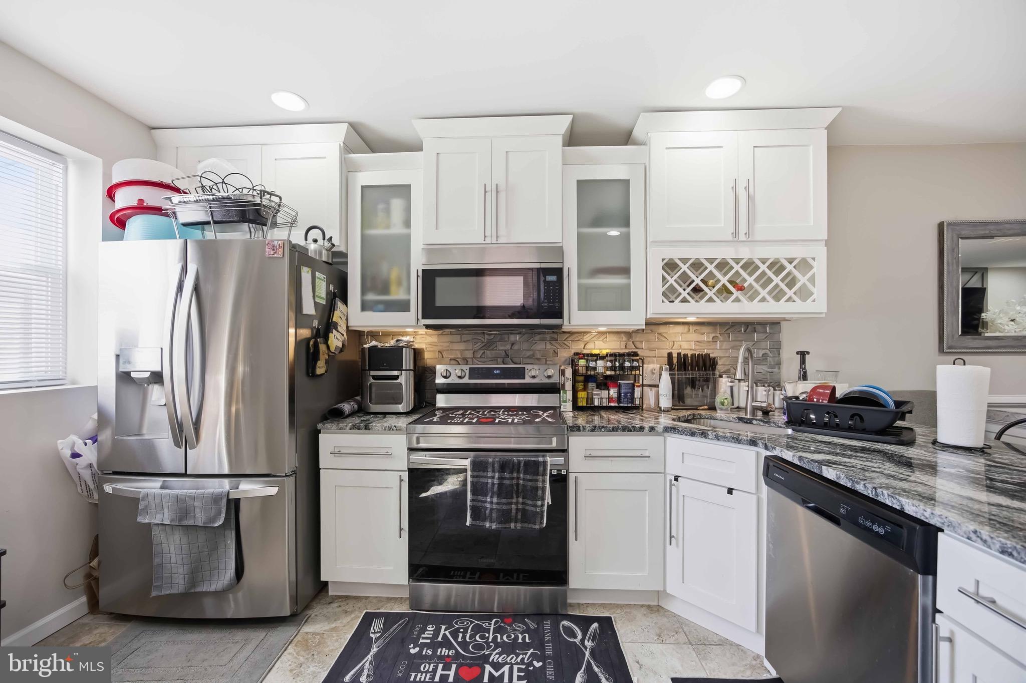 7167 Georgian Road Philadelphia, PA 19138 - Photo 16 of 34 a kitchen with a refrigerator and a stove top oven