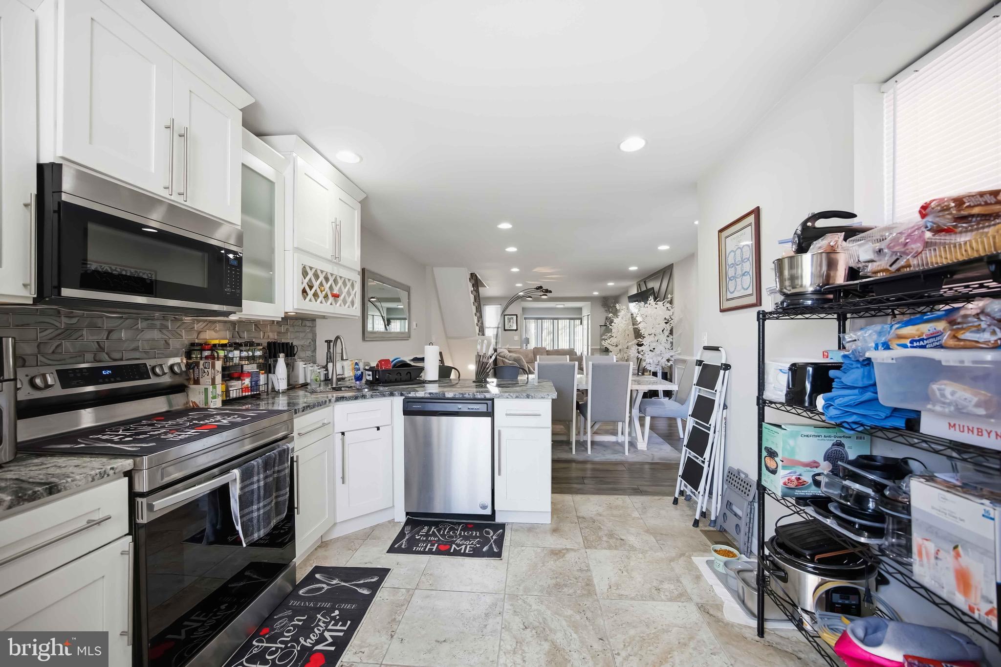 7167 Georgian Road Philadelphia, PA 19138 - Photo 17 of 34 a kitchen with lots of counter top space stove and cabinets