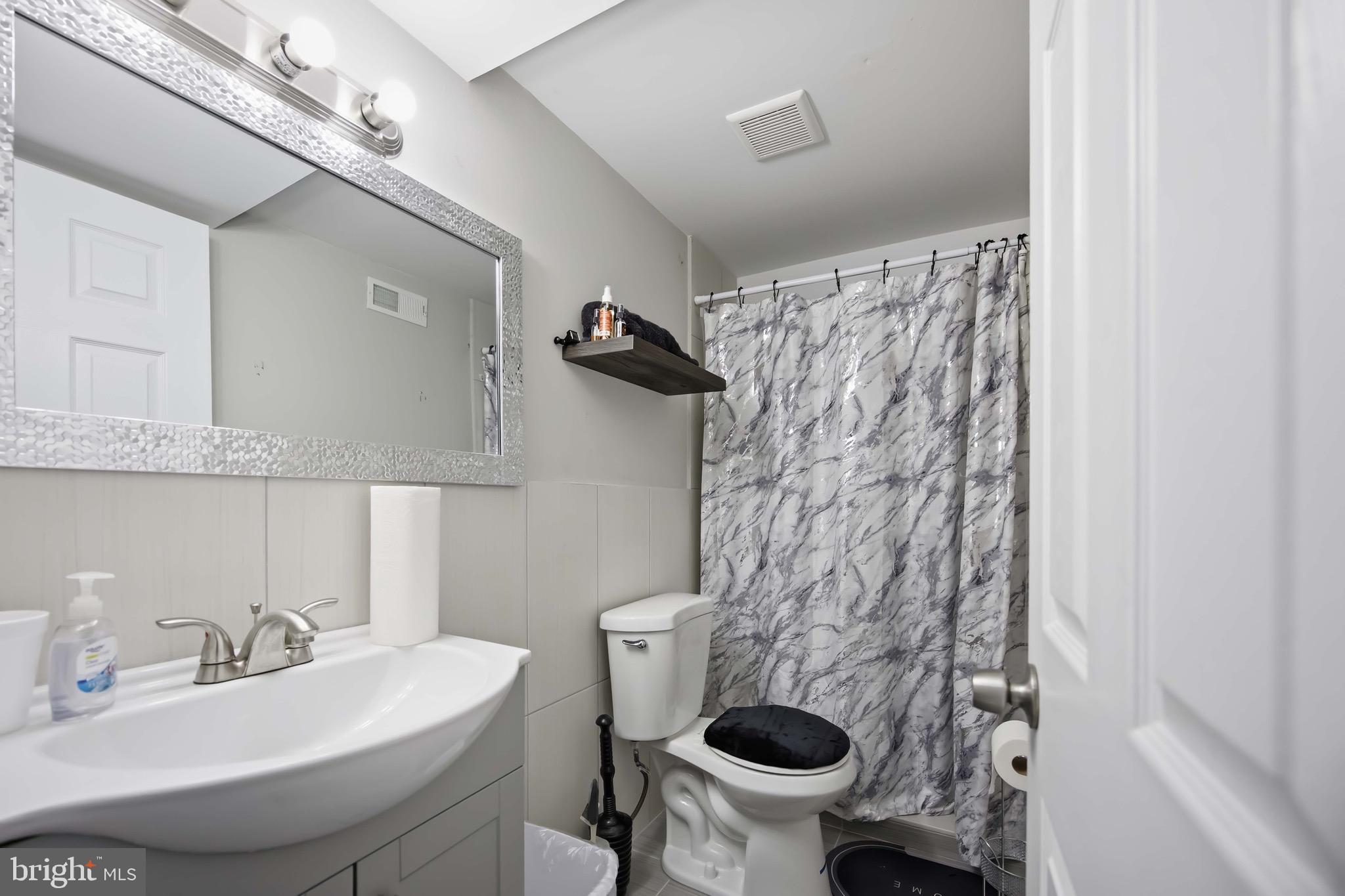 7167 Georgian Road Philadelphia, PA 19138 - Photo 21 of 34 a bathroom with a sink and a toilet