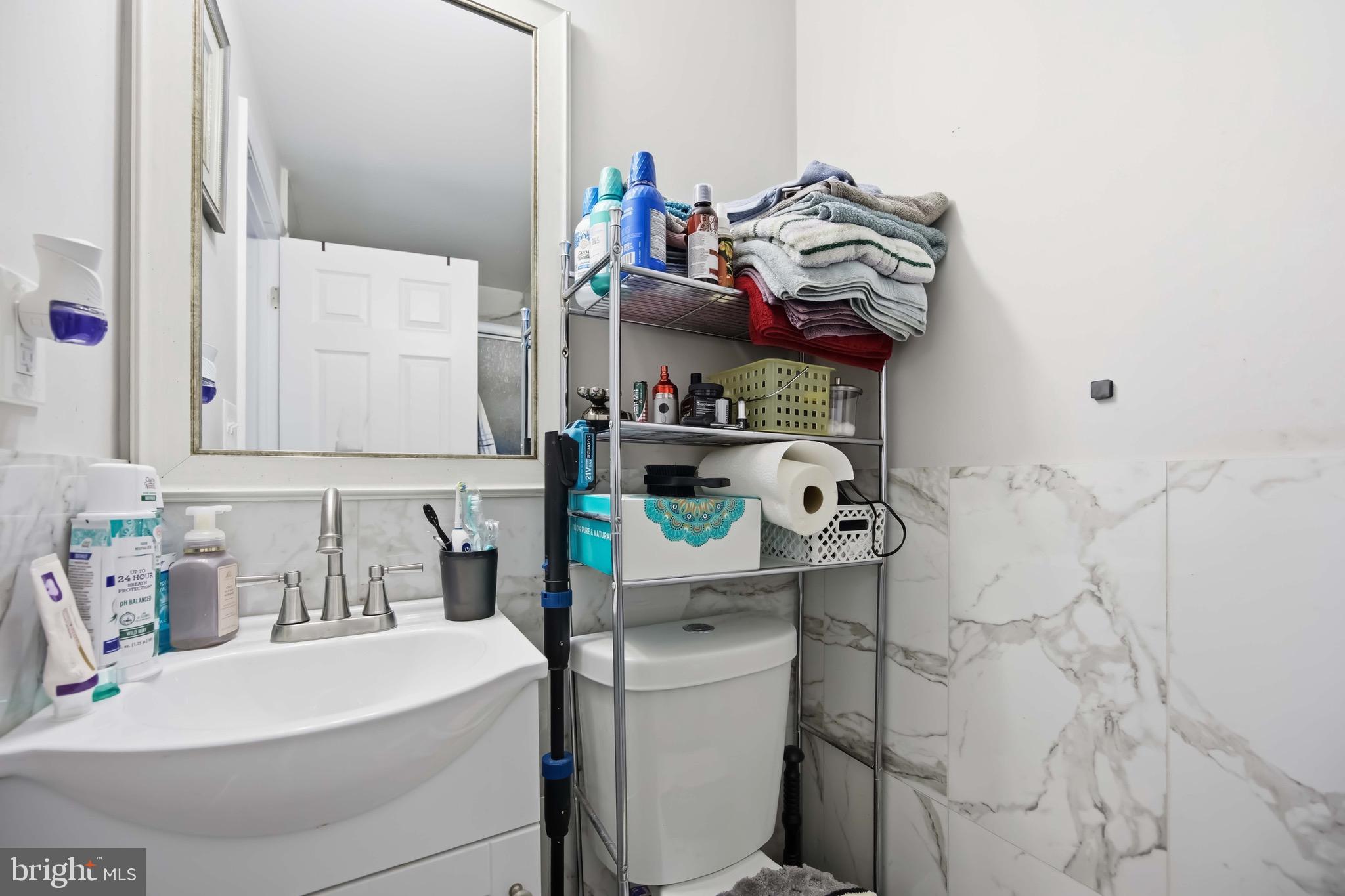 7167 Georgian Road Philadelphia, PA 19138 - Photo 29 of 34 a white bath tub sitting next to a white sink and cabinets