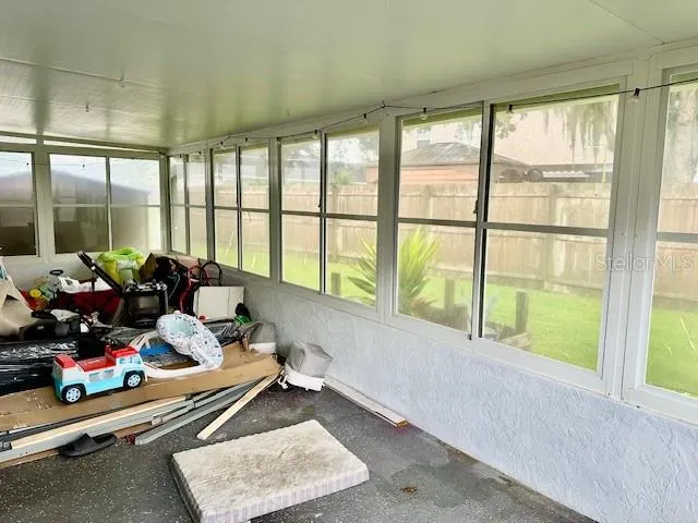 a room with furniture and large windows