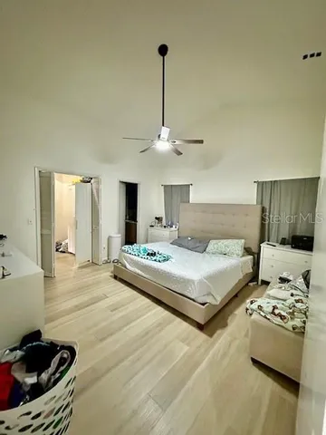 a bedroom with a bed and a chandelier