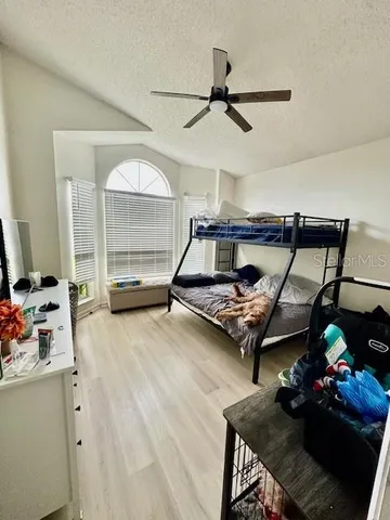 a bed room with furniture and a wooden floor