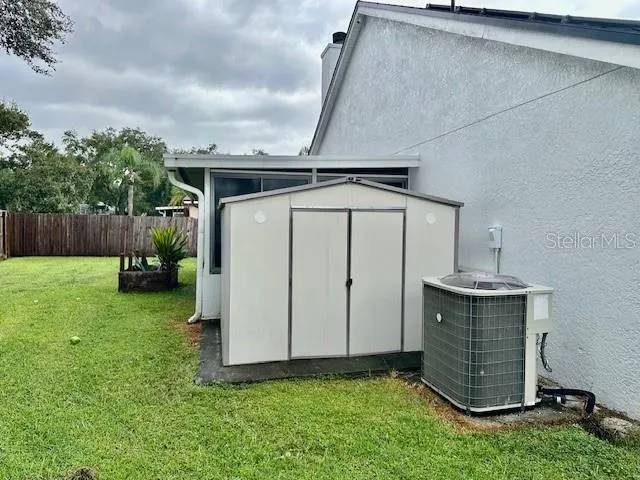 a view of a backyard with plants and a tub