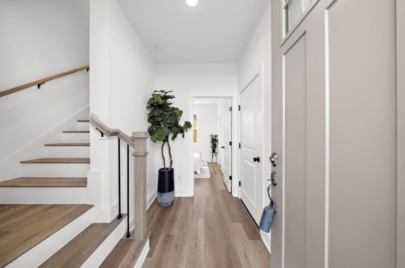 835 Elkhart Street, Unit B Houston, TX 77091 - Photo 3 of 14 a view of a hallway with wooden floor and staircase