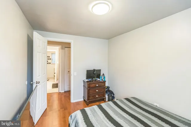 a bedroom with a bed and a television