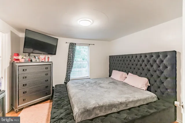 a bedroom with a bed and flat screen tv