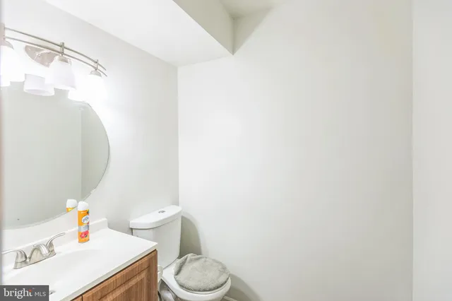 a white toilet sitting next to a bathroom sink