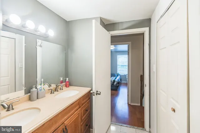 a en suite bathroom with a sink double vanity and a mirror