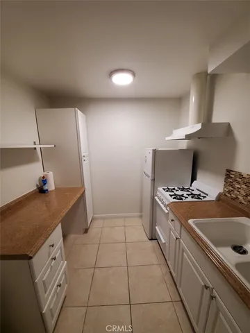 a kitchen with a sink a stove and refrigerator