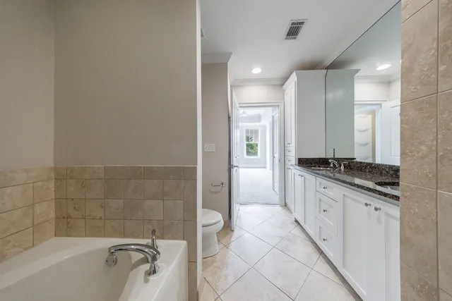 a bathroom with a granite countertop bathtub shower sink and mirror