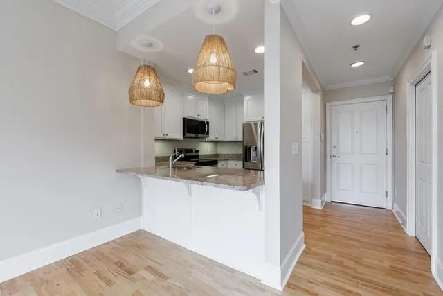 a view of living room with wooden floor