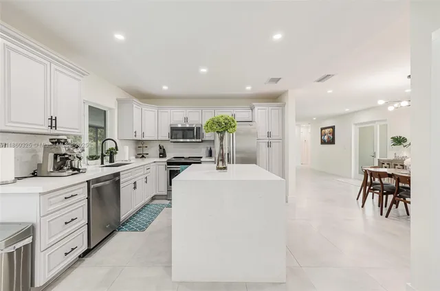 a kitchen with cabinets and chairs