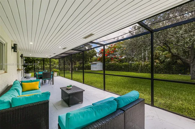 a view of a patio with a table chairs and a backyard