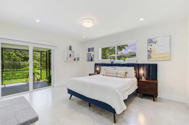 a bedroom with a bed and a large window