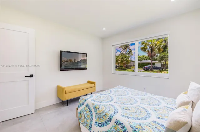 a bedroom with a bed and a painting on the wall