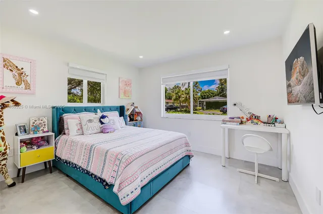 a bedroom with a bed and a desk