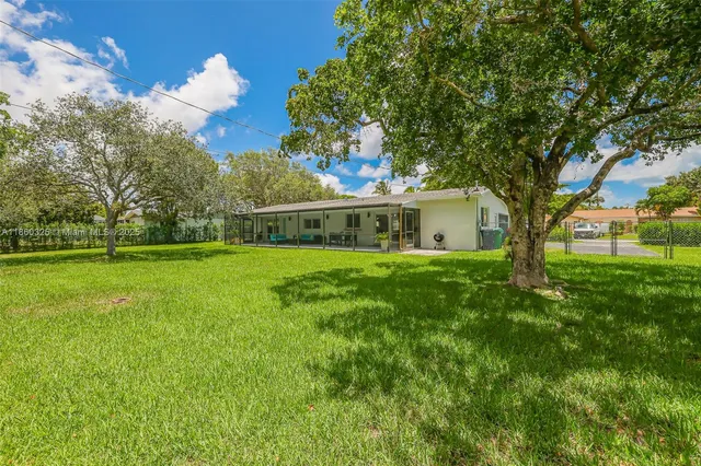 a house view with swimming pool in front of it