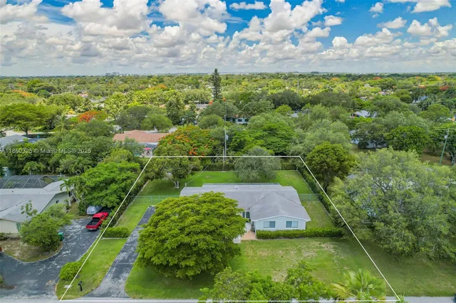 a view of a pathway with a garden
