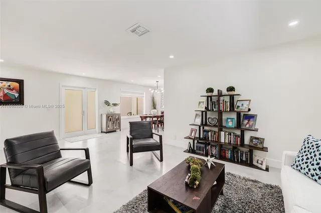 a living room with furniture and a book shelf