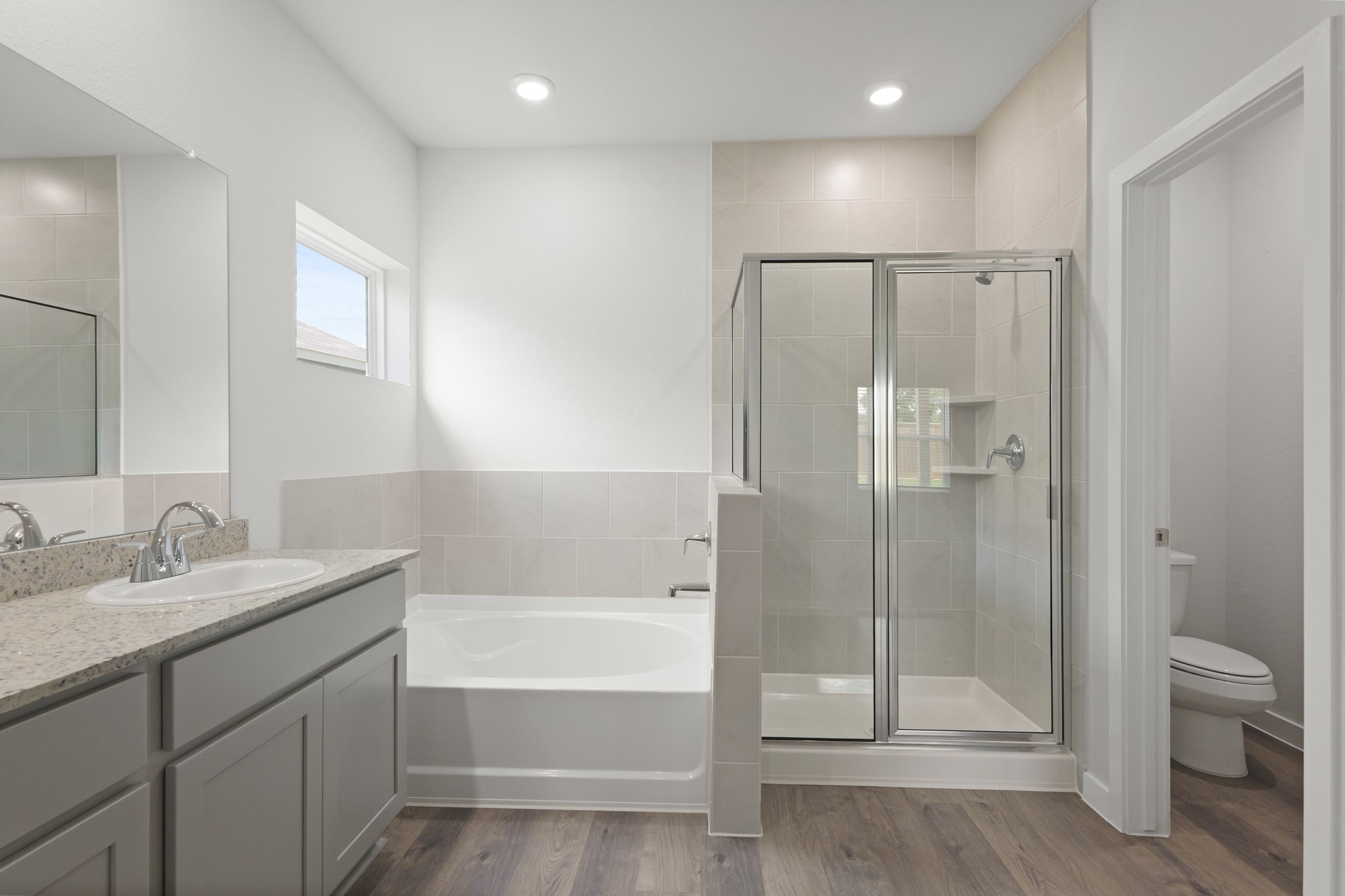 529 Shoreview Drive Conroe, TX 77303 - Photo 16 of 34 a bathroom with a granite countertop sink a toilet and shower