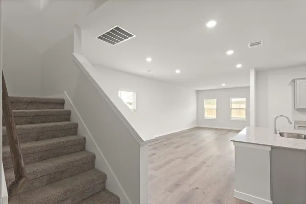 a view of entryway and hall with wooden floor