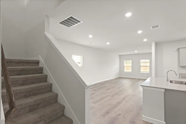 a view of entryway and hall with wooden floor