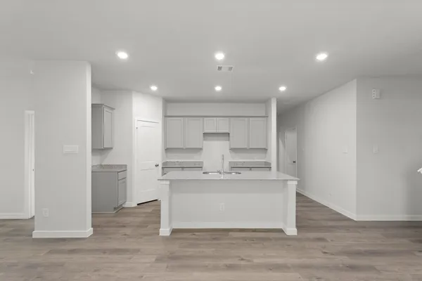 a view of kitchen with stainless steel appliances refrigerator sink and cabinets