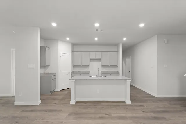 a view of kitchen with stainless steel appliances refrigerator sink and cabinets