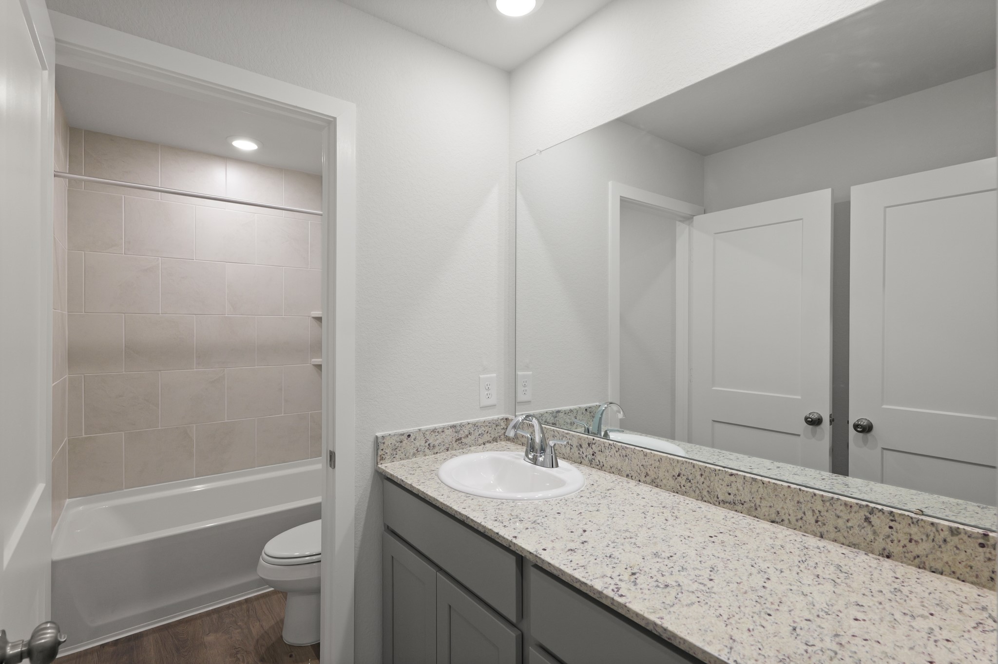 529 Shoreview Drive Conroe, TX 77303 - Photo 26 of 34 a bathroom with a granite countertop sink toilet and shower