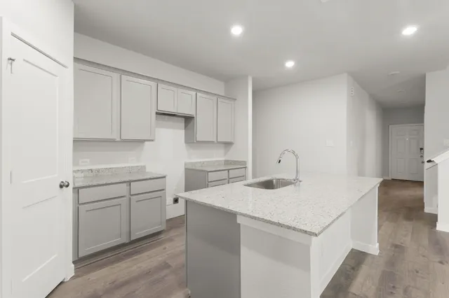 a kitchen that has a sink and a stove in it