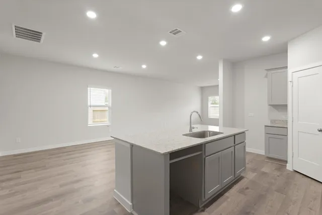 a kitchen with a sink stove and refrigerator